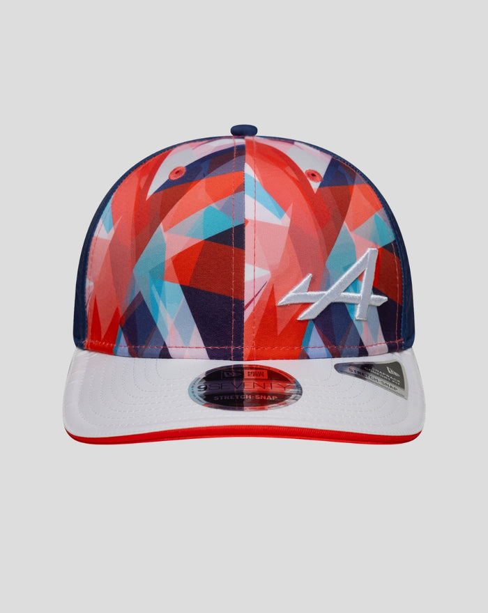 Front view of a New Era Alpine cap featuring a vibrant geometric crown, white brim with red edge, and a white stitched A logo.
