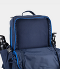 Front lower pocket of navy Built for Athletes 45L Backpack with pink stitched panel and blue zippers.