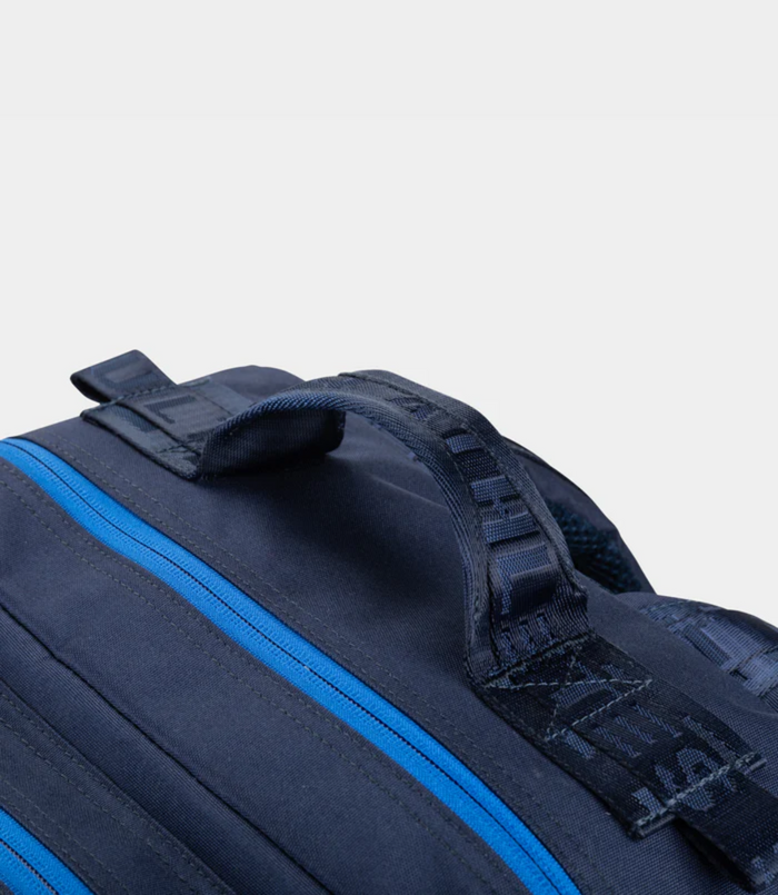 Close-up of navy Built for Athletes 45L backpack showing a blue zipper and strap details