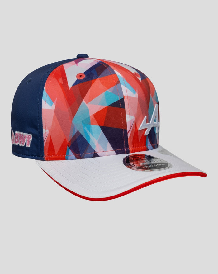 Side view of the cap displaying blue back panel, multicolored geometric crown, and pink BWT embroidery.