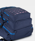 Top portion of navy backpack with vivid blue zipper and handle, highlighting the compact design