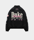 Back view of a black BWT Alpine racing jacket by Duke and Dexter showing large white Duke Racing typography and Miami Race Week branding across the back