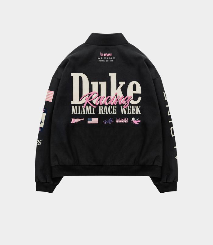 Back view of a black BWT Alpine racing jacket by Duke and Dexter showing large white Duke Racing typography and Miami Race Week branding across the back