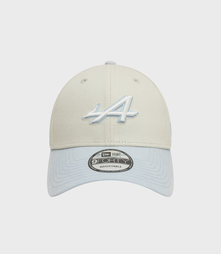 Beige creme crown 9Forty cap with a light blue brim viewed from the front with sticker on the brim