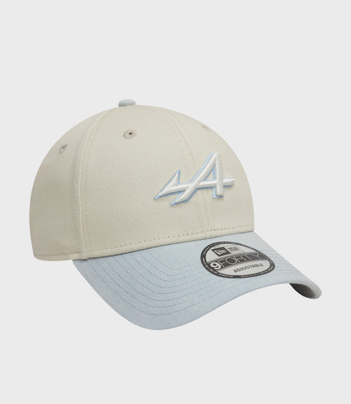 Beige Alpine 9Forty cap with a blue brim top button visible and embroidered logo on the side