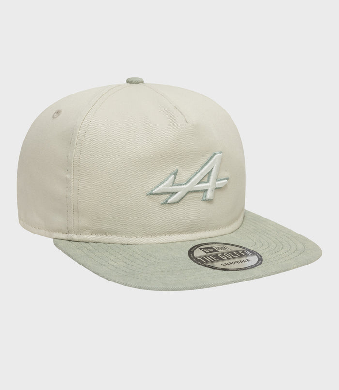 Side view of the Alpine Acid Wash Golfer Cap showing mint visor and pale blue embroidery on the crown with a sticker on the brim