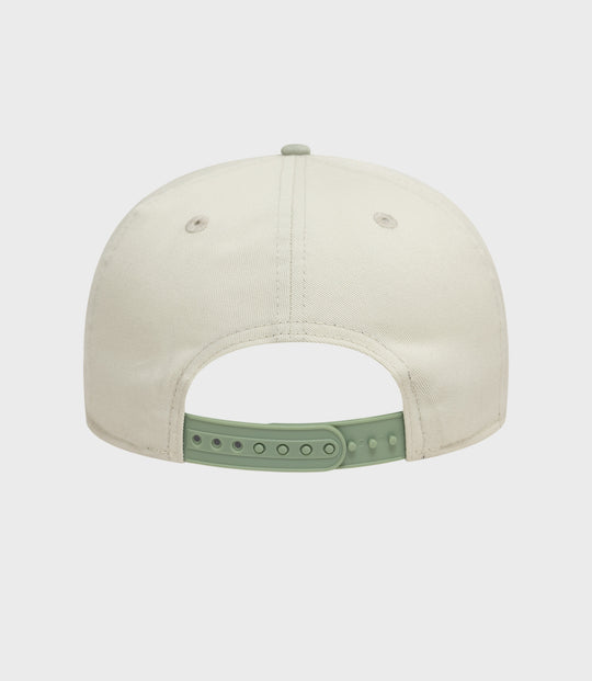 Top view of white New Era Alpine acid wash golfer cap with mint green back strap