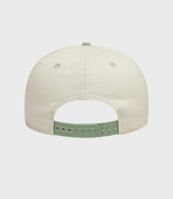 Top view of white New Era Alpine acid wash golfer cap with mint green back strap