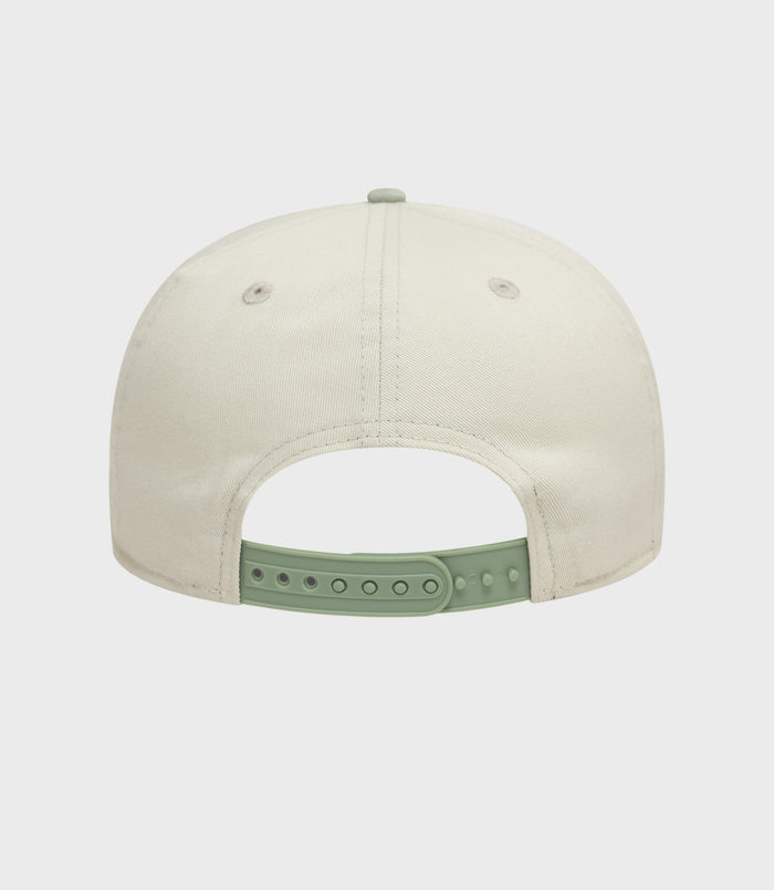 Top view of white New Era Alpine acid wash golfer cap with mint green back strap