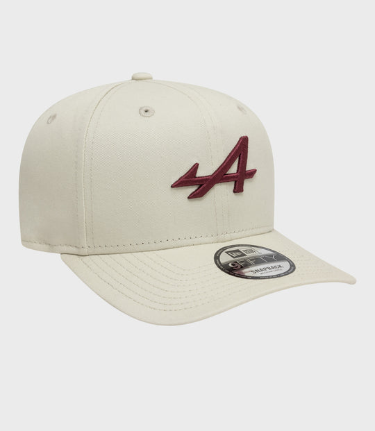Angled view of white New Era Alpine Seasonal 9Fifty cap with burgundy embroidery on the front panel