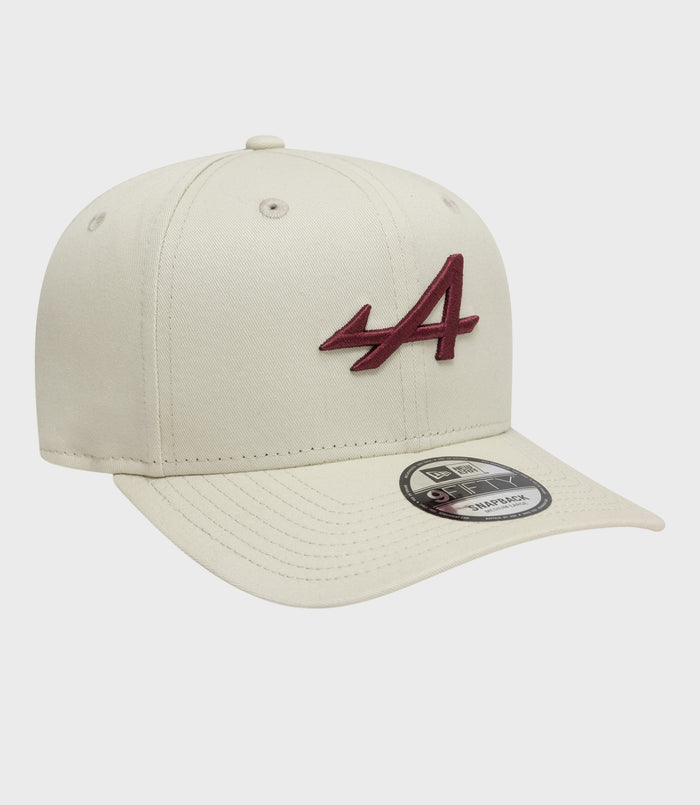 Angled view of white New Era Alpine Seasonal 9Fifty cap with burgundy embroidery on the front panel