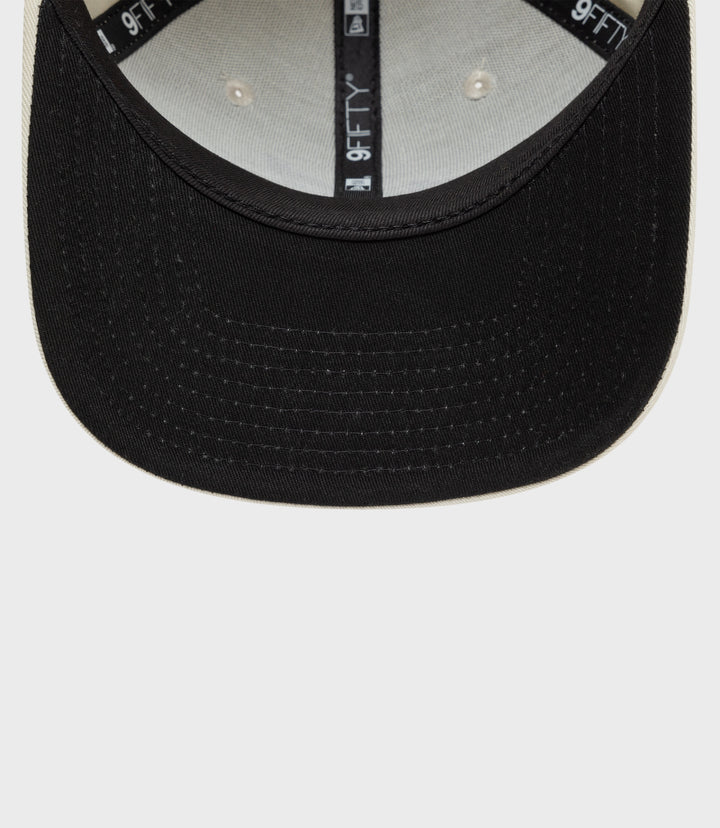 Interior of New Era Alpine 9Fifty cap with cotton crown and light underside, 9FIFTY tape along the crown seam