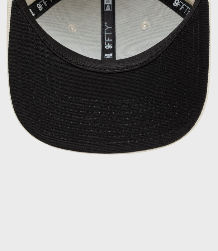 Interior of New Era Alpine 9Fifty cap with cotton crown and light underside, 9FIFTY tape along the crown seam