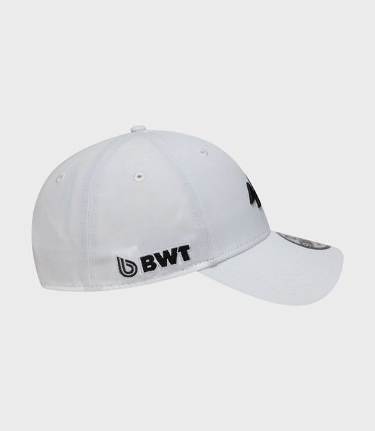 White cap shown from side with black embroidered logo, BWT label on the side, and brim sticker visible.