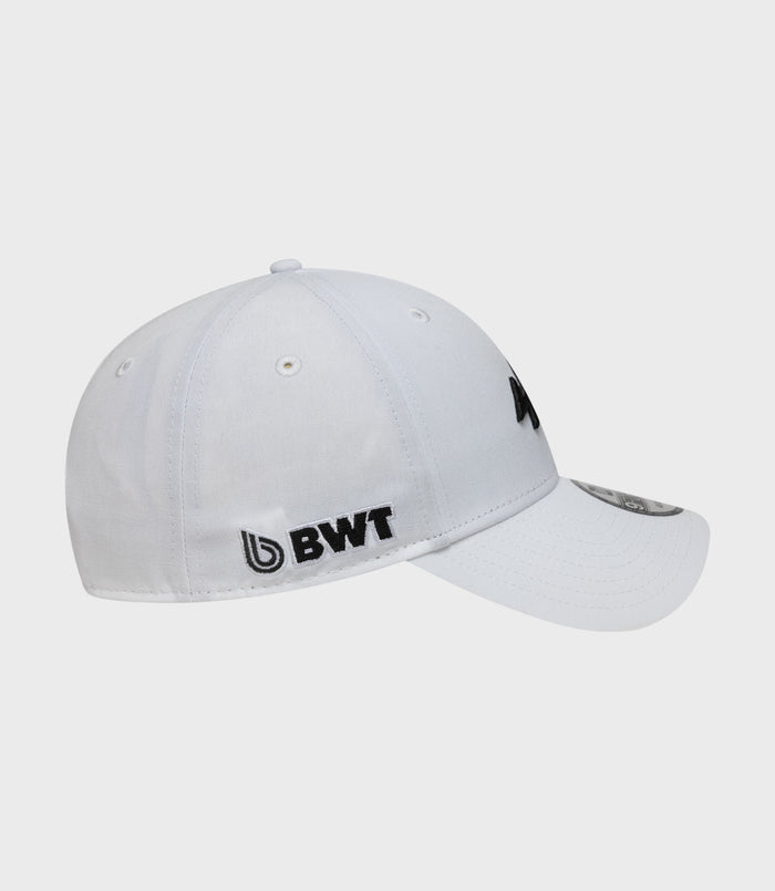 White cap shown from side with black embroidered logo, BWT label on the side, and brim sticker visible.