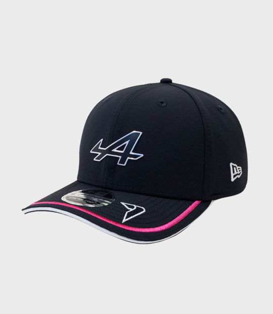 Navy New Era 9Seventy Stretch Snap Cap with a large white front logo, pink trim on the brim, and a New Era emblem on the side.