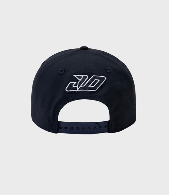 Back view of navy cap with adjustable snap closure and pink piping along the edge of the brim