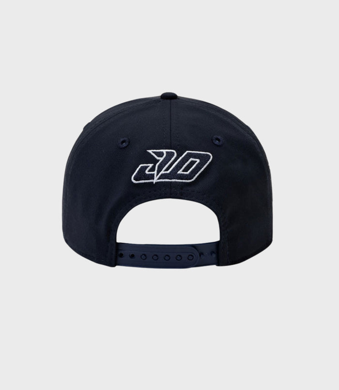 Back view of navy cap with adjustable snap closure and pink piping along the edge of the brim