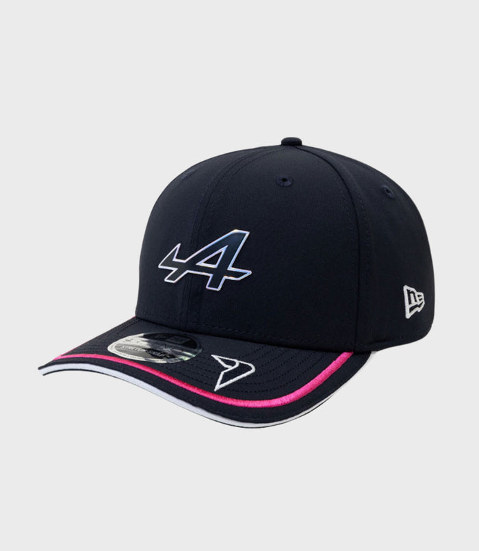 Navy New Era 9Seventy Stretch Snap Cap with a large white front logo, pink trim on the brim, and a New Era emblem on the side.