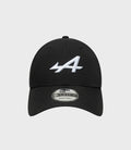 Top view of black cap with small crown button and partial white embroidery on the front panel.
