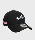 Black cap with pink embroidered side patch and New Era 9FORTY adjustable sticker visible on the brim.