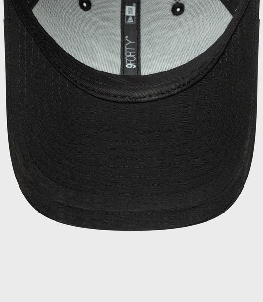 Close up of the black cap brim with inner 9FORTY label on the hat interior