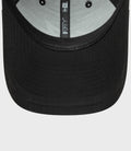 Close up of the black cap brim with inner 9FORTY label on the hat interior