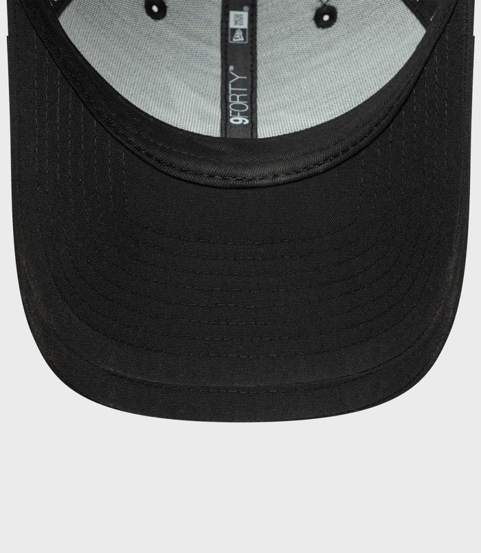 Close up of the black cap brim with inner 9FORTY label on the hat interior