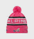 Pink Alpine cuff knit hat with fluffy pom and striped cuff showing ALPINE lettering