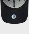 Inside view of navy Alpine Repreve 9Forty cap showing light gray undervisor and 9Forty label along the crown