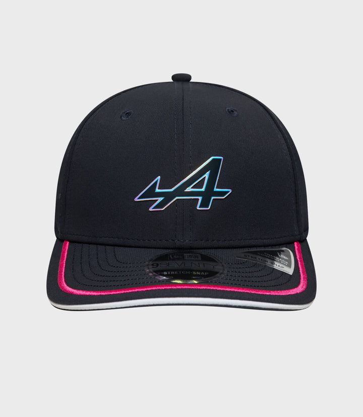 Front view of navy cap with iridescent logo on the crown and pink trim on the brim
