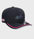 Angled shot of navy stretch snap cap showing iridescent logo on the front and pink brim edge