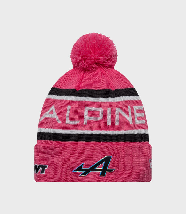 Bright pink knit junior pop hat with a large fluffy pom and ribbed cuff