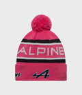 Bright pink knit junior pop hat with a large fluffy pom and ribbed cuff
