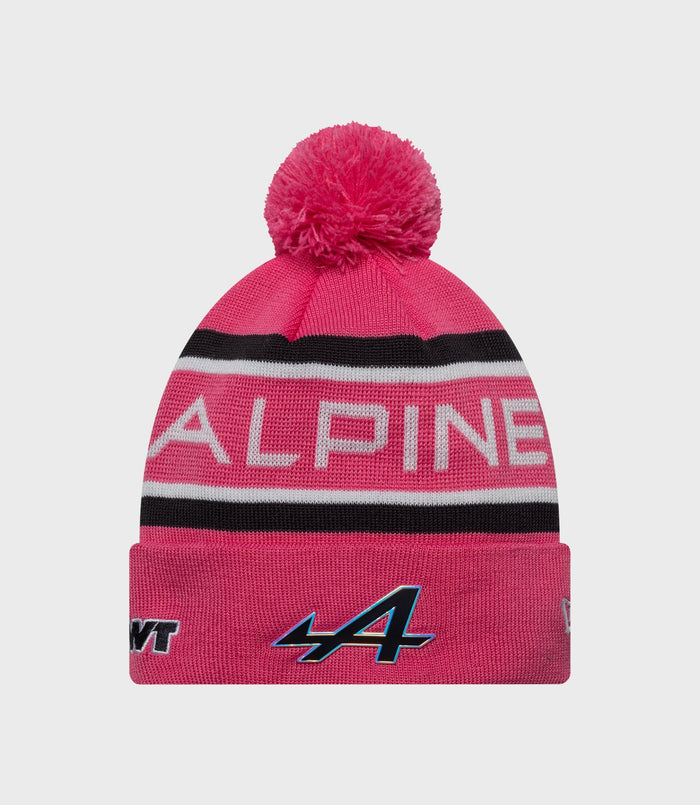 Bright pink knit junior pop hat with a large fluffy pom and ribbed cuff
