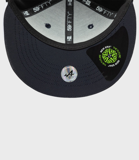 Inside view of navy cap showing gray lining and 59FIFTY branding on the inner tape with a circular New Era sticker on the brim.