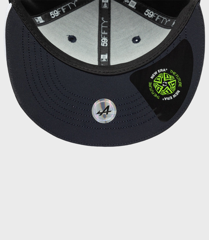 Inside view of navy cap showing gray lining and 59FIFTY branding on the inner tape with a circular New Era sticker on the brim.