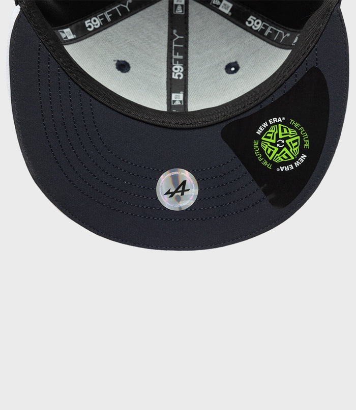 Inside view of navy cap showing gray lining and 59FIFTY branding on the inner tape with a circular New Era sticker on the brim.