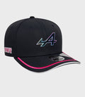 Side view of navy Alpine 9Seventy Junior cap with iridescent logo on the crown and pink piping on the brim