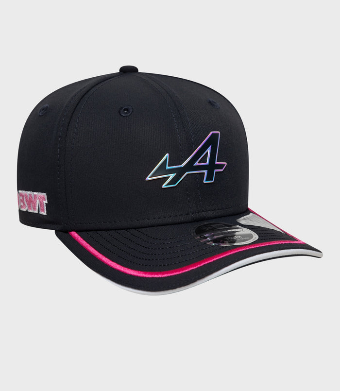 Side view of navy Alpine 9Seventy Junior cap with iridescent logo on the crown and pink piping on the brim