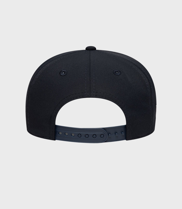 Back view of navy New Era Alpine 9Seventy cap with an adjustable plastic snap strap