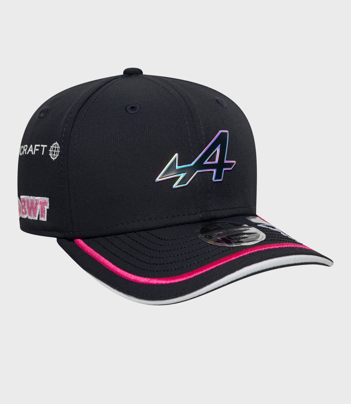 Front view of navy cap with large holographic logo and pink piping along the brim