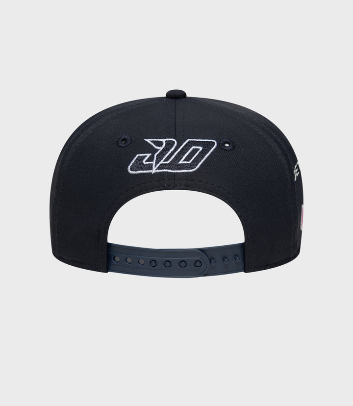 Rear view of navy cap with white embroidered logo on crown panels