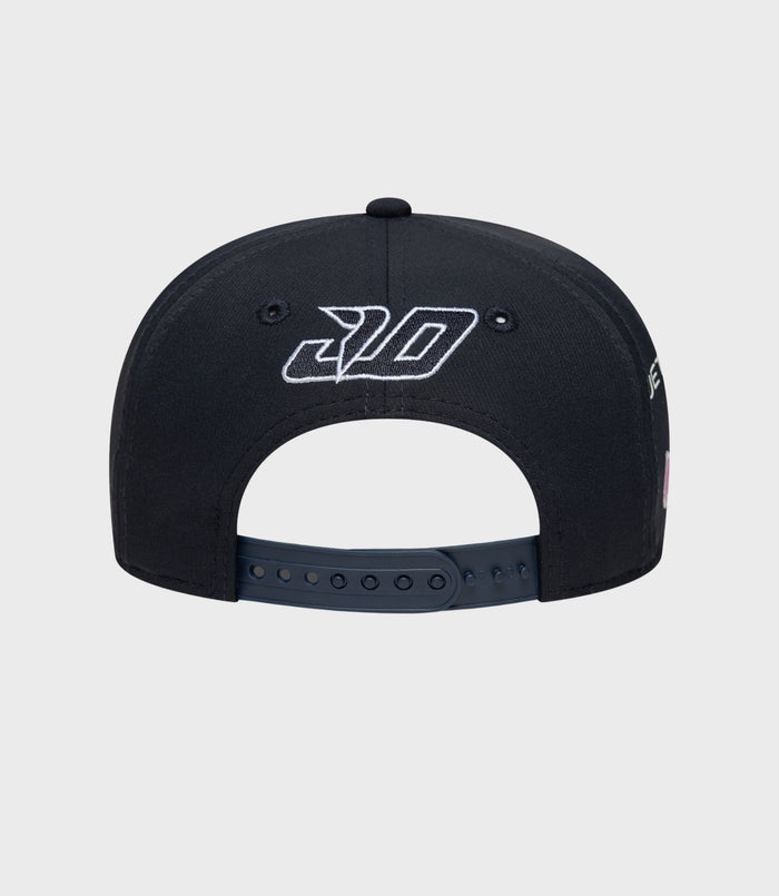 Rear view of navy cap with white embroidered logo on crown panels