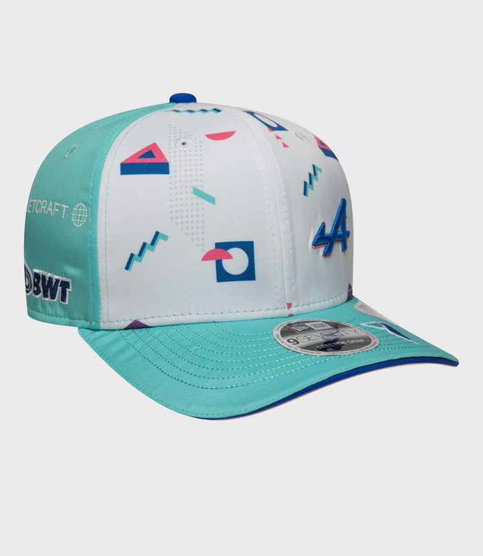 Front side view of teal and white graphic cap with geometric patterns and a 9Seventy sticker on the brim