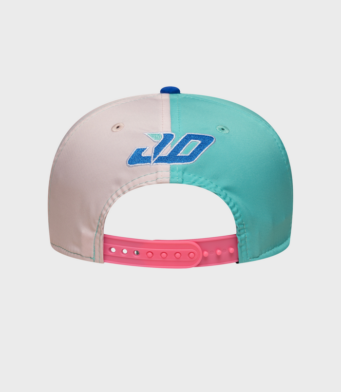 Top view of the cap with blue button, white crown with graphics and turquoise brim.