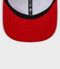 Inside view of white 9Seventy cap showing red under brim and black trim along the edge