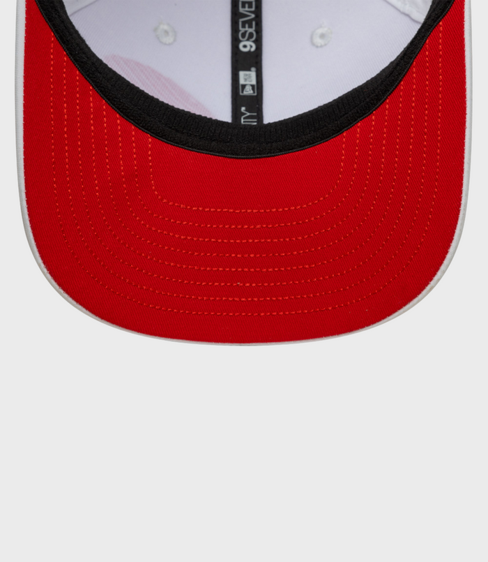 Inside view of white 9Seventy cap showing red under brim and black trim along the edge