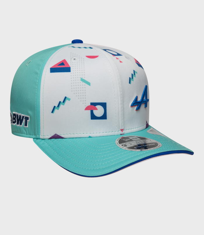 Close-up of New Era Alpine Miami 9Seventy Stretch Snap Cap in white with turquoise side panels and geometric print.