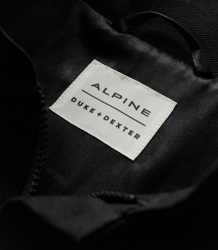 Interior label on the jacket reading ALPINE DUKE & DEXTER on light fabric